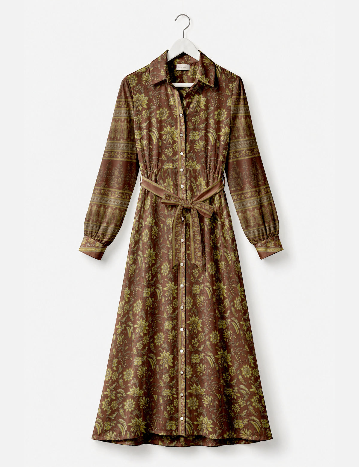 Long brown shirt dress with yellow floral and paisley print, button front, long sleeves, collar, and waist tie belt on hanger