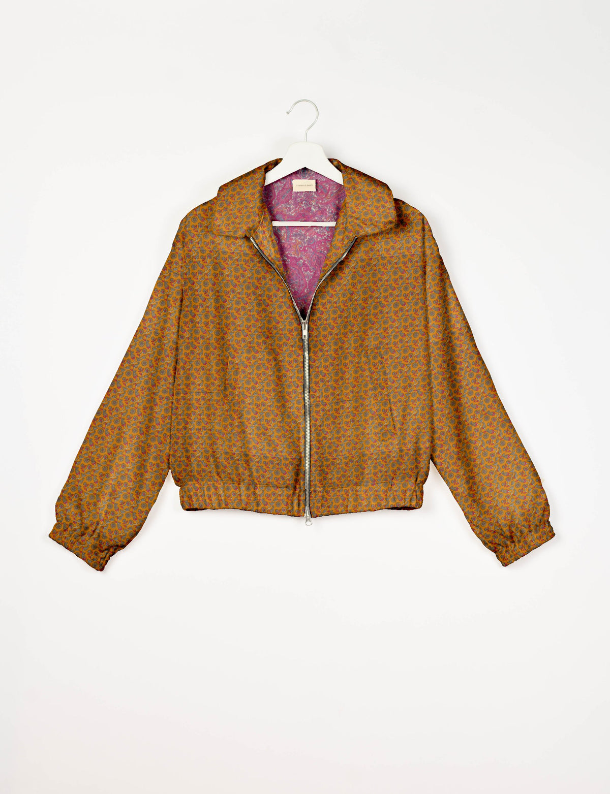 Yellow bomber jacket with tropical floral pattern, front zipper, elastic cuffs and hem, shown on white hanger front view