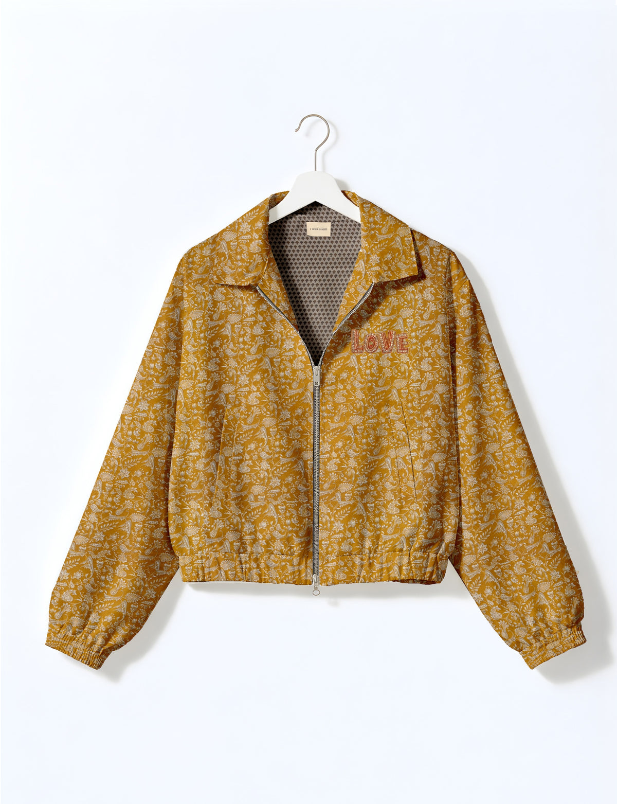 Love Bomber Jacket made from recycled fabric, featuring hand-stitched Aari embroidery. A unique piece of zero-waste clothing, part of the circular fashion movement. Designed with upcycled materials for a stylish yet environmentally friendly clothing choice.