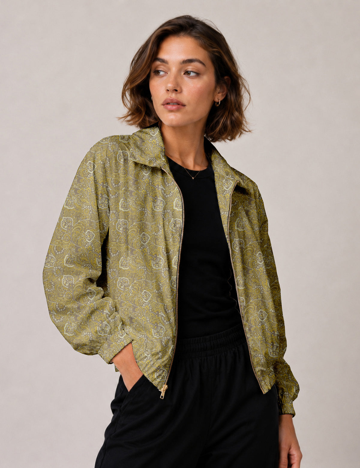 Brown floral bomber jacket with front zipper, elastic cuffs and hem, hanging on white hanger, red floral inner lining visible
