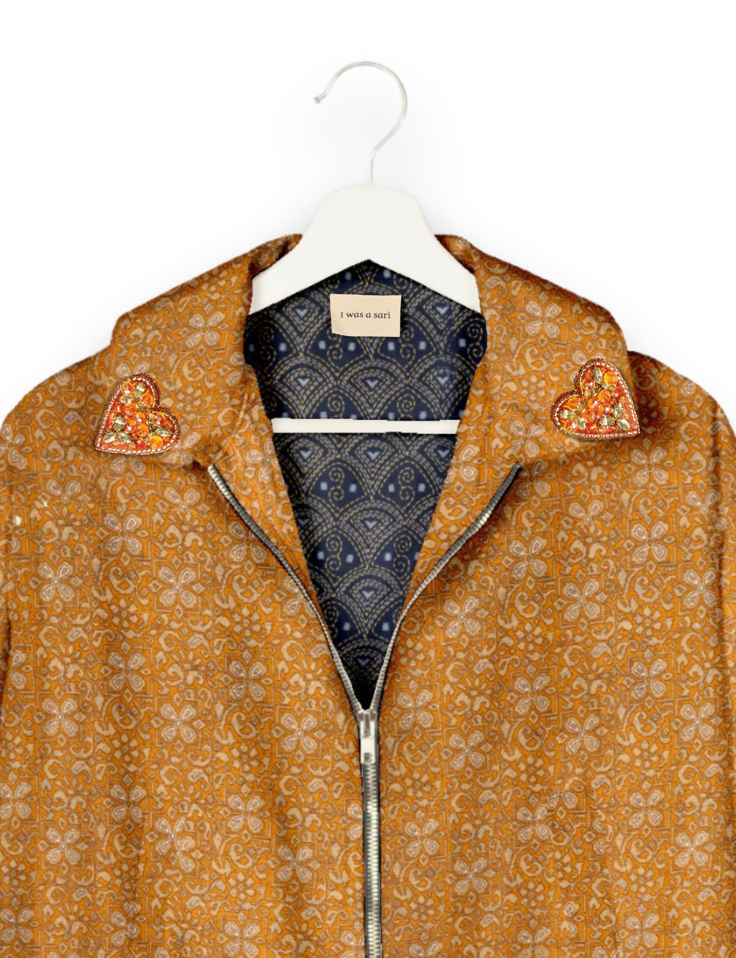 Make a bold statement with our Heart Drop Earrings, a symbol of conscious luxury and ethical fashion. Handcrafted using the intricate Aari embroidery technique, these earrings are made from upcycled sari fabric, embracing slow fashion and zero waste clothing. Elevate your look with sustainable apparel that supports fair trade fashion while reducing textile waste. Choose eco-friendly fashion that speaks of love, artistry, and responsibility.