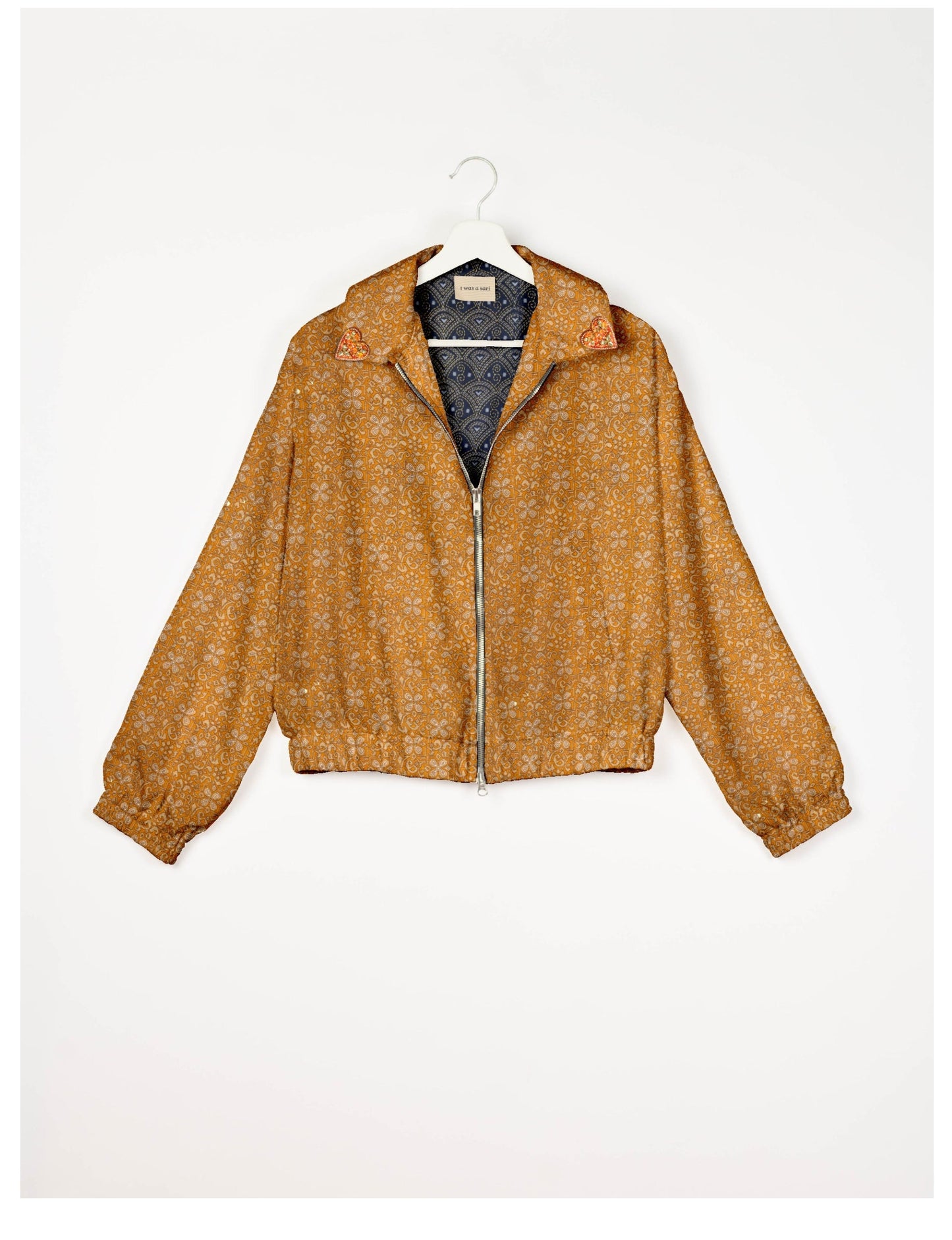 Make a bold statement with our Heart Drop Earrings, a symbol of conscious luxury and ethical fashion. Handcrafted using the intricate Aari embroidery technique, these earrings are made from upcycled sari fabric, embracing slow fashion and zero waste clothing. Elevate your look with sustainable apparel that supports fair trade fashion while reducing textile waste. Choose eco-friendly fashion that speaks of love, artistry, and responsibility.