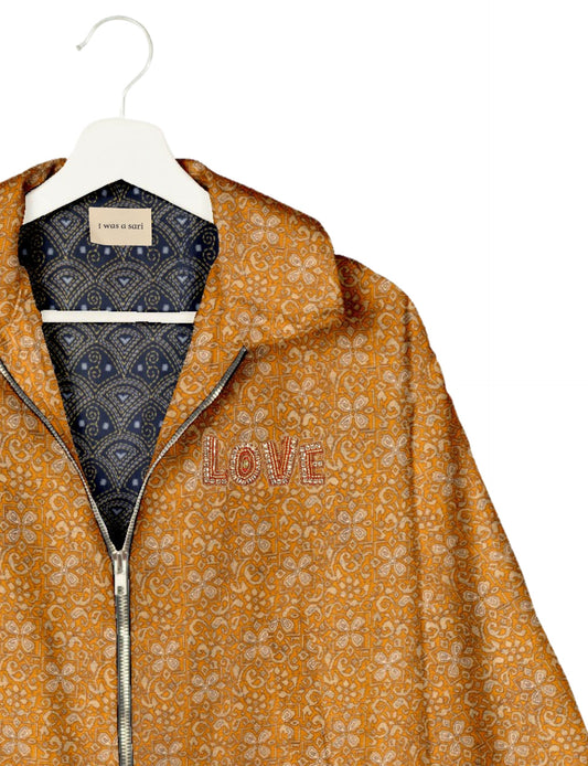 Love Bomber Jacket made from recycled fabric, featuring hand-stitched Aari embroidery. A unique piece of zero-waste clothing, part of the circular fashion movement. Designed with upcycled materials for a stylish yet environmentally friendly clothing choice.
