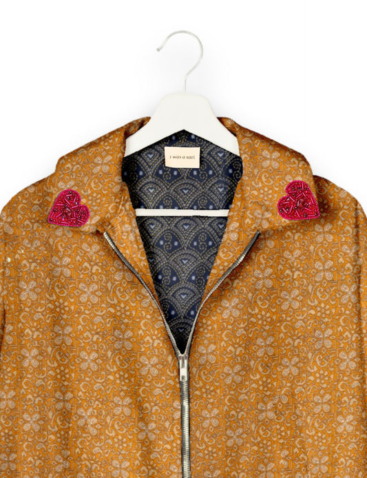 Make a bold statement with our Heart Drop Earrings, a symbol of conscious luxury and ethical fashion. Handcrafted using the intricate Aari embroidery technique, these earrings are made from upcycled sari fabric, embracing slow fashion and zero waste clothing. Elevate your look with sustainable apparel that supports fair trade fashion while reducing textile waste. Choose eco-friendly fashion that speaks of love, artistry, and responsibility.