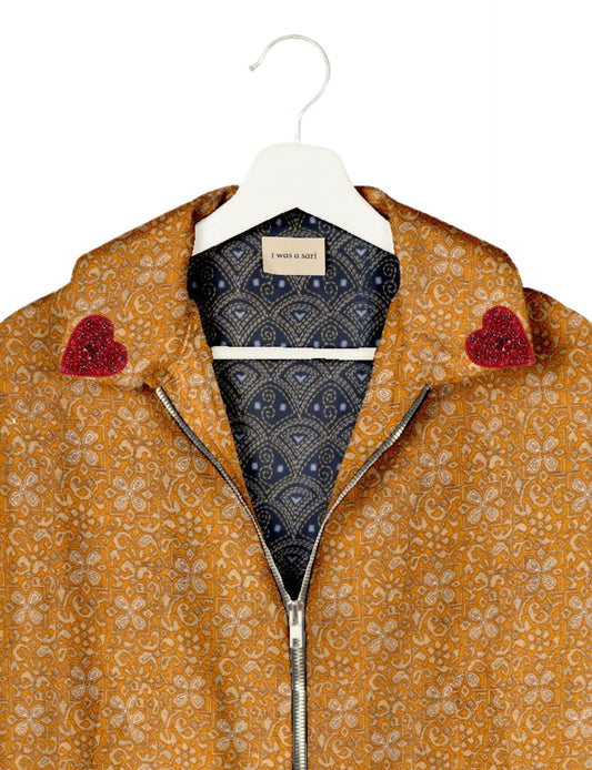 Make a bold statement with our Heart Drop Earrings, a symbol of conscious luxury and ethical fashion. Handcrafted using the intricate Aari embroidery technique, these earrings are made from upcycled sari fabric, embracing slow fashion and zero waste clothing. Elevate your look with sustainable apparel that supports fair trade fashion while reducing textile waste. Choose eco-friendly fashion that speaks of love, artistry, and responsibility.