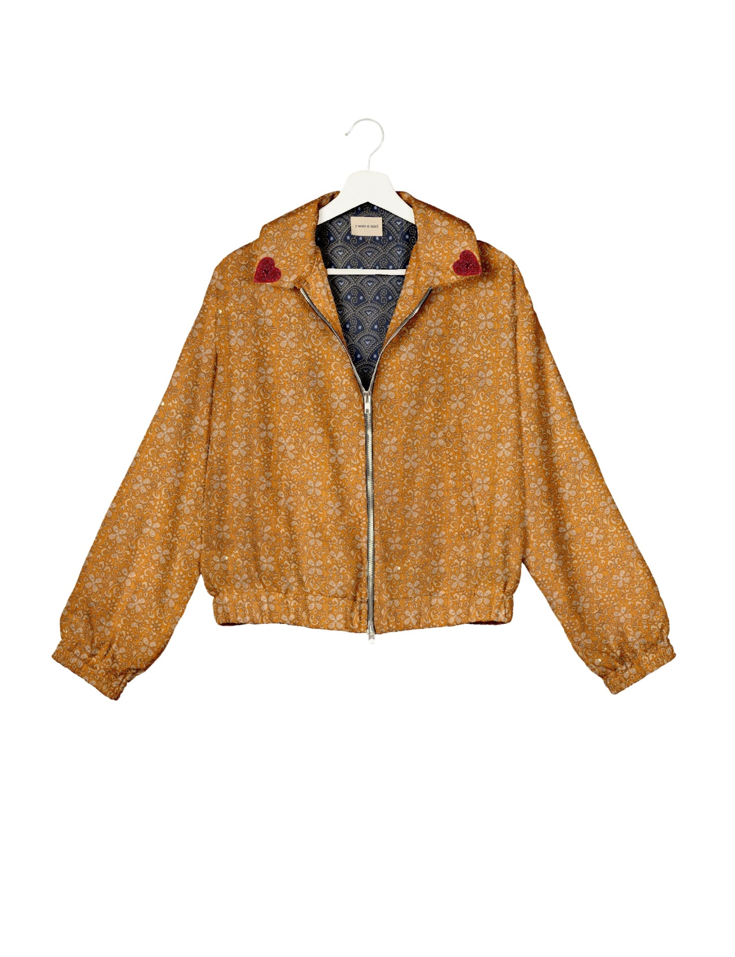 Make a bold statement with our Heart Drop Earrings, a symbol of conscious luxury and ethical fashion. Handcrafted using the intricate Aari embroidery technique, these earrings are made from upcycled sari fabric, embracing slow fashion and zero waste clothing. Elevate your look with sustainable apparel that supports fair trade fashion while reducing textile waste. Choose eco-friendly fashion that speaks of love, artistry, and responsibility.