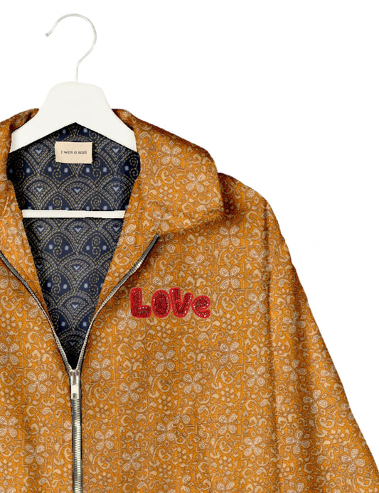 Love Bomber Jacket made from recycled fabric, featuring hand-stitched Aari embroidery. A unique piece of zero-waste clothing, part of the circular fashion movement. Designed with upcycled materials for a stylish yet environmentally friendly clothing choice.