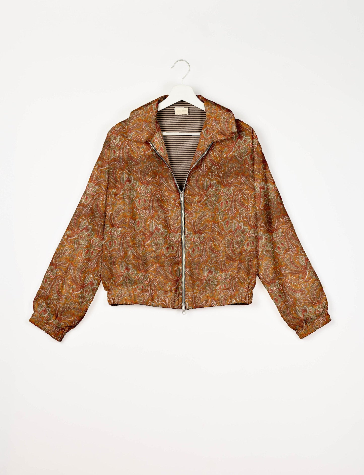 Stylish BOMBER JACKET, an upcycled clothing masterpiece with a cute cropped shape, elasticated details, and detachable metallic zipper. Contrast sari print lining adds a unique touch. Explore sustainable and eco-friendly fashion.