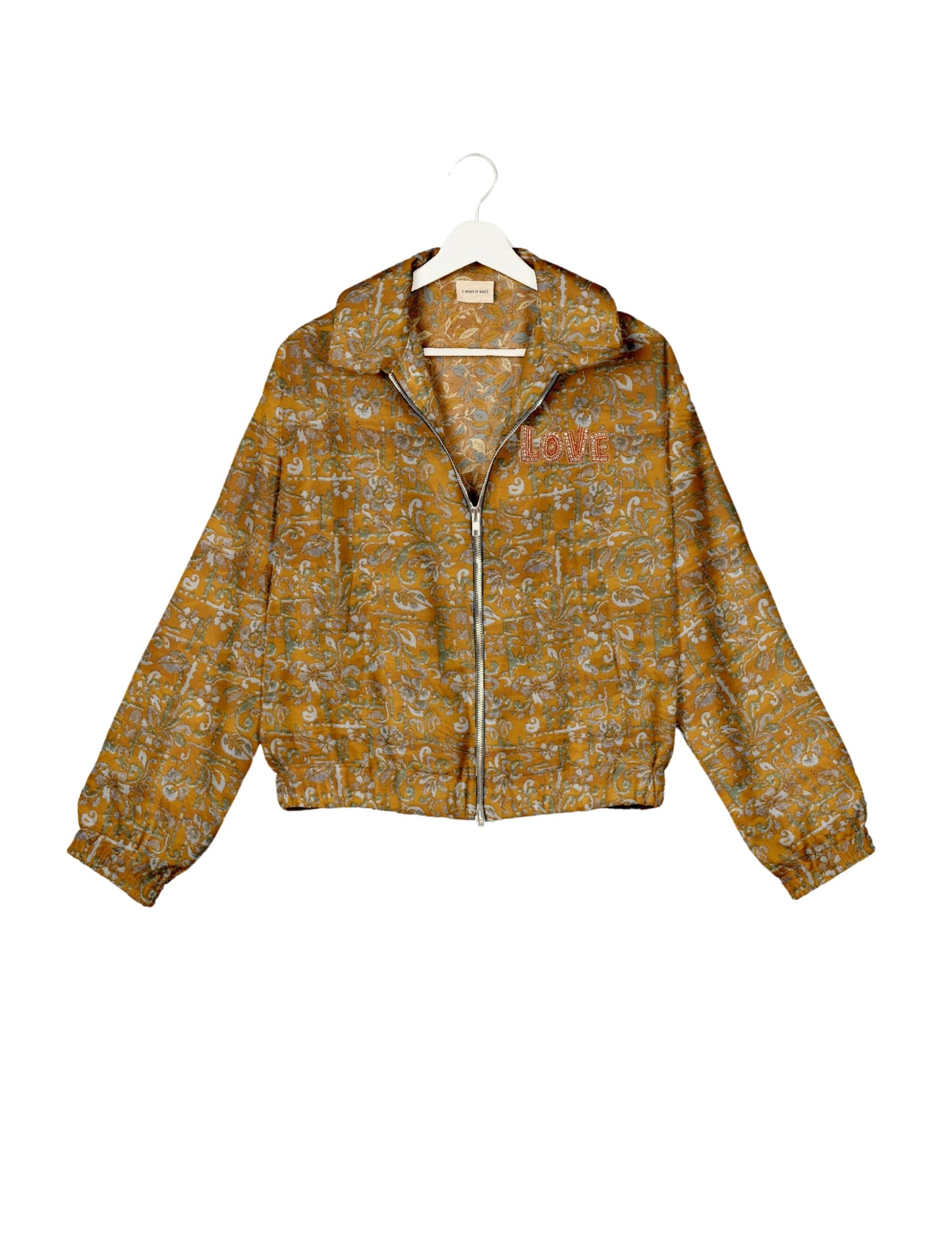 Love Bomber Jacket made from recycled fabric, featuring hand-stitched Aari embroidery. A unique piece of zero-waste clothing, part of the circular fashion movement. Designed with upcycled materials for a stylish yet environmentally friendly clothing choice.