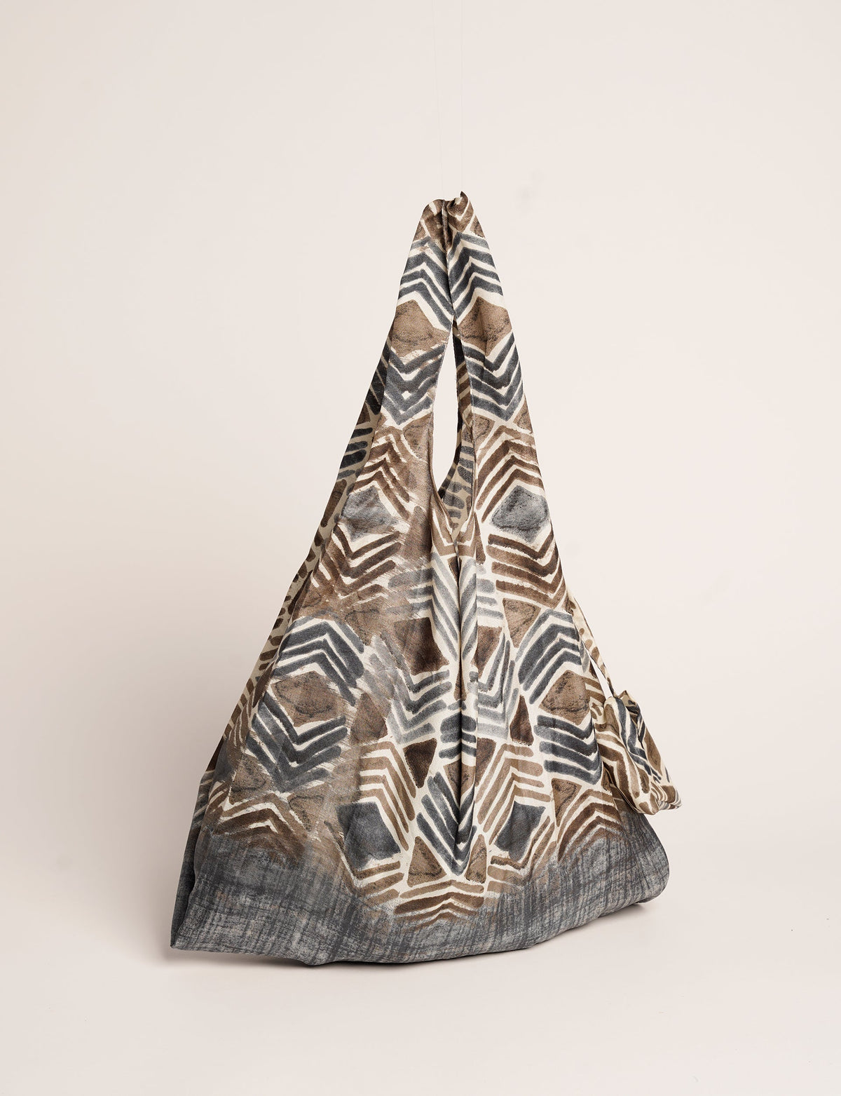 Stay eco-conscious with our Reusable Bag, handmade by Indian artisans from pre-loved saris. Silky and lightweight, this foldaway bag is perfect for your on-the-go lifestyle. Each piece is a unique statement of ethical fashion, embracing sustainability and style.