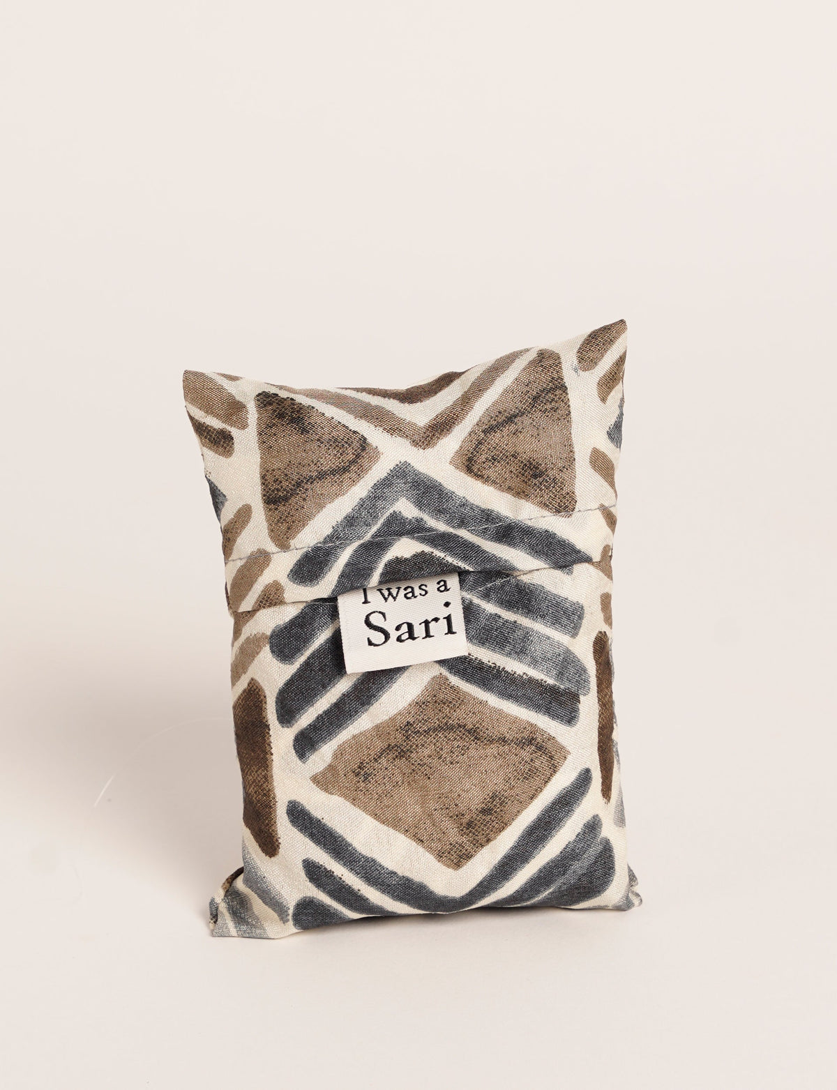 Stay eco-conscious with our Reusable Bag, handmade by Indian artisans from pre-loved saris. Silky and lightweight, this foldaway bag is perfect for your on-the-go lifestyle. Each piece is a unique statement of ethical fashion, embracing sustainability and style.