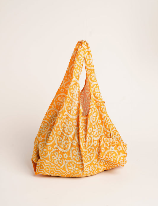 Stay eco-conscious with our Reusable Bag, handmade by Indian artisans from pre-loved saris. Silky and lightweight, this foldaway bag is perfect for your on-the-go lifestyle. Each piece is a unique statement of ethical fashion, embracing sustainability and style.