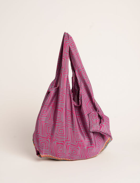 Stay eco-conscious with our Reusable Bag, handmade by Indian artisans from pre-loved saris. Silky and lightweight, this foldaway bag is perfect for your on-the-go lifestyle. Each piece is a unique statement of ethical fashion, embracing sustainability and style.