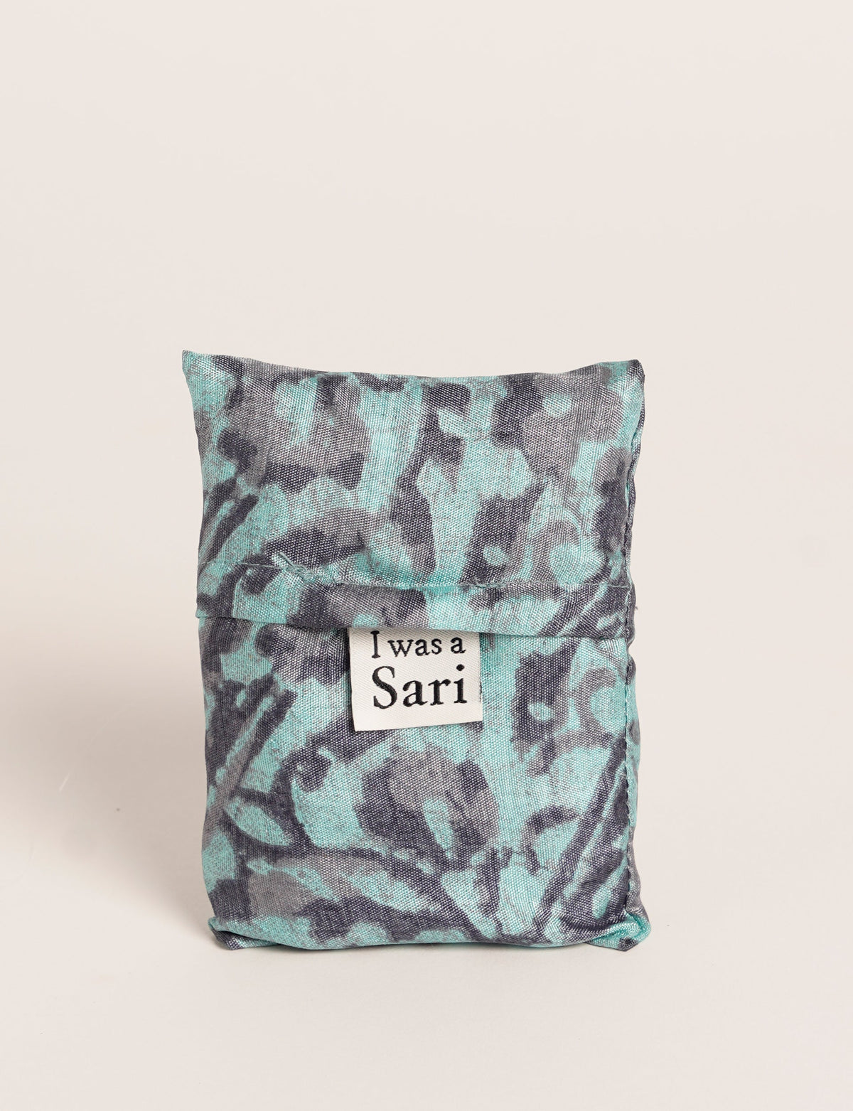 Stay eco-conscious with our Reusable Bag, handmade by Indian artisans from pre-loved saris. Silky and lightweight, this foldaway bag is perfect for your on-the-go lifestyle. Each piece is a unique statement of ethical fashion, embracing sustainability and style.