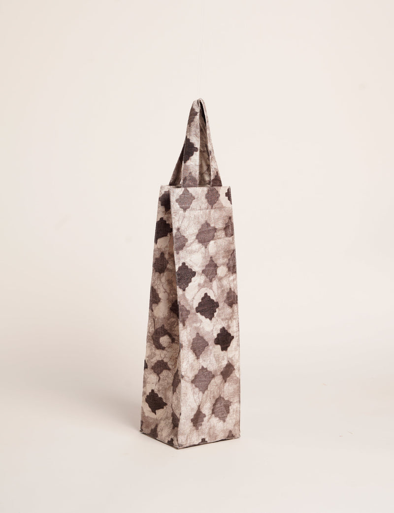 Brown organic fabric wine bag with dark geometric pattern, standing upright with handles visible at top