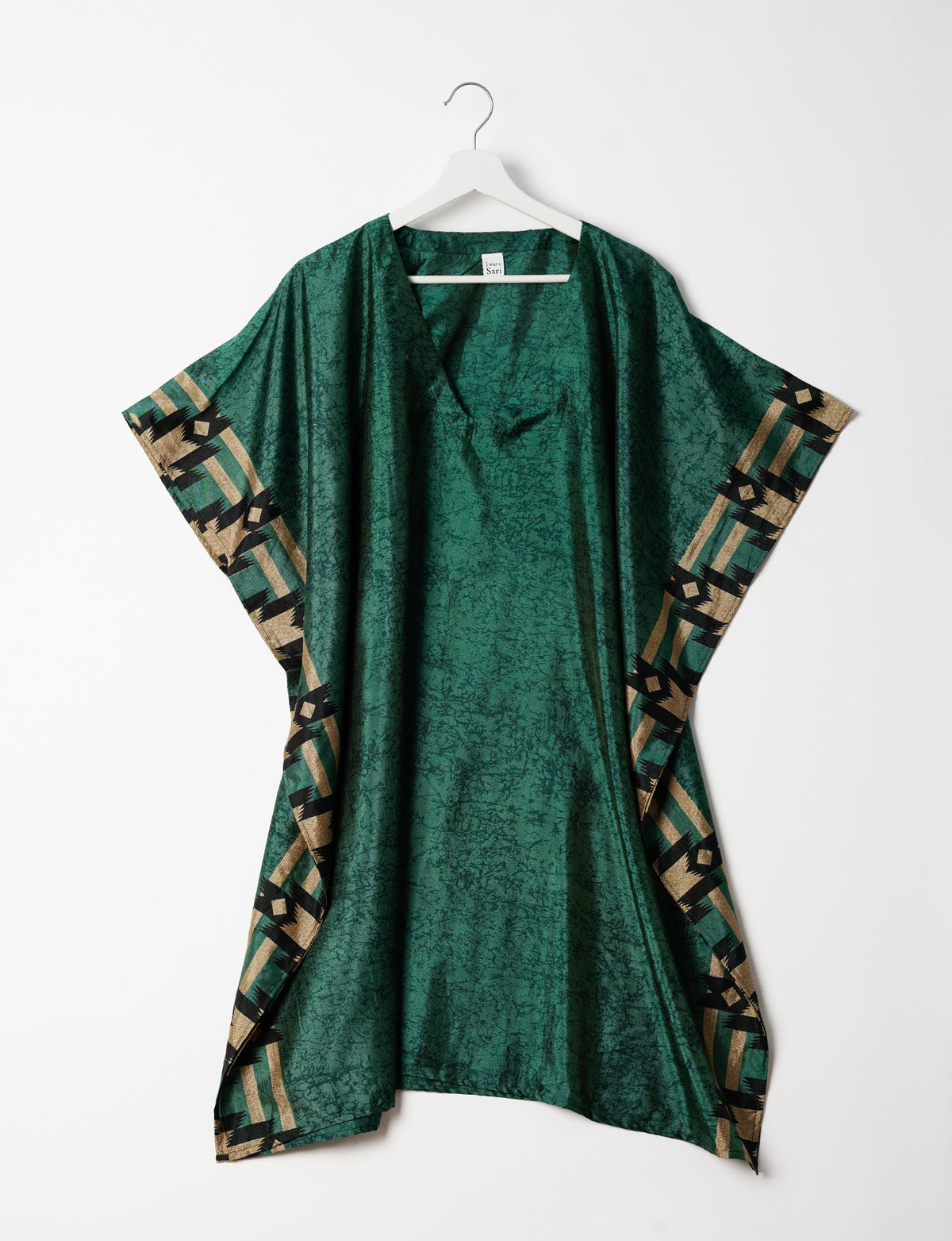 Flowing and festive KAFTAN, an essential for your getaway wardrobe. Versatile for at-home lounging or poolside cocktails. Accessorize with our silk pouches or tote bag for a socially-conscious and stylish look, perfect even for dinner outings. Crafted from sustainable materials, this eco-friendly kaftan adds a touch of conscious fashion to your style.