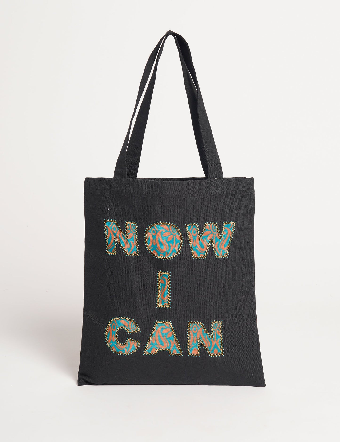 Discover empowerment with our NOW I CAN TOTE BAG – a distinctive piece from our embroidery collection, commemorating positive transformations in the lives of our women artisans. Each bag signifies empowerment, from community pride to supporting education dreams. Carefully crafted with embroidered signatures, these bags are not only visually appealing but also embody the artisans' journeys and the reincarnation of pre-loved saris into a new form – as your treasured bag.