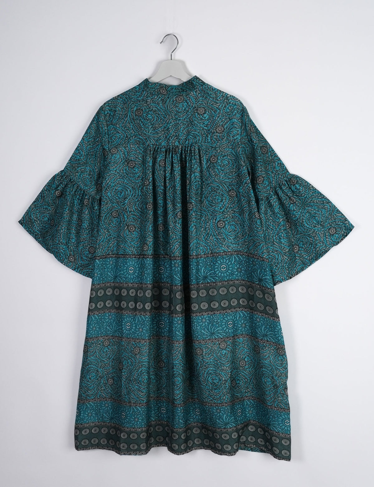 Discover ethical elegance with our Bell Sleeve Coat, handcrafted by Indian artisans from recycled materials. This sustainable fashion piece is a statement in eco-friendly clothing, combining style and consciousness effortlessly.