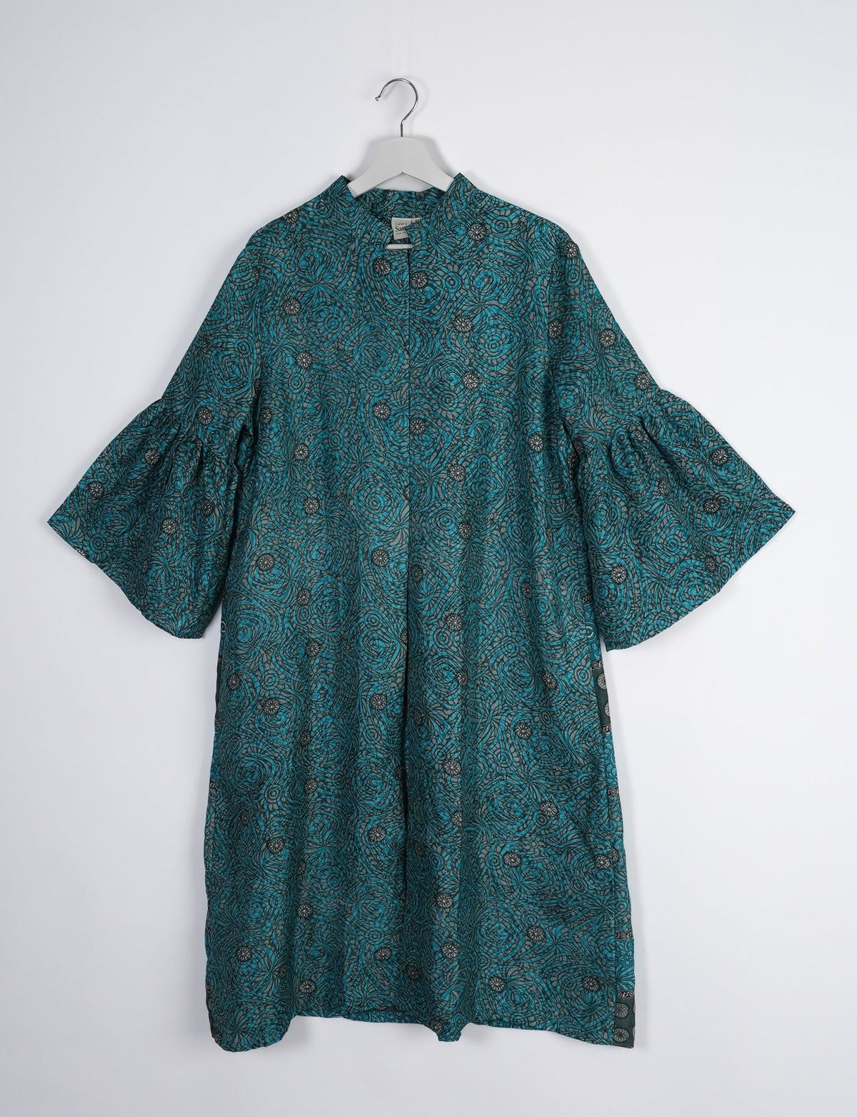Discover ethical elegance with our Bell Sleeve Coat, handcrafted by Indian artisans from recycled materials. This sustainable fashion piece is a statement in eco-friendly clothing, combining style and consciousness effortlessly.