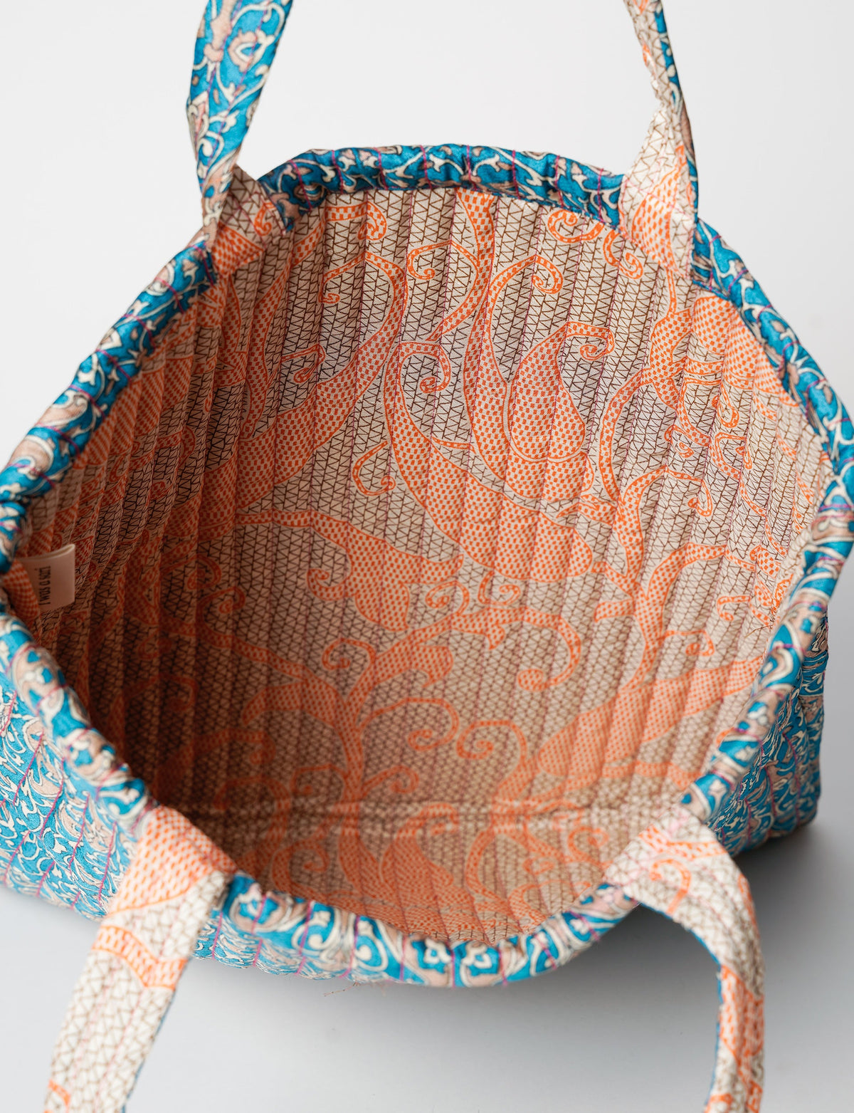 Elevate your style sustainably with our QUILTED SHOPPER BAG. Soft textures, vibrant colors, and a positive impact on people and the planet. Perfect for the office, shopping, or happy hour. Crafted from pre-loved saris for eco-conscious fashionistas!