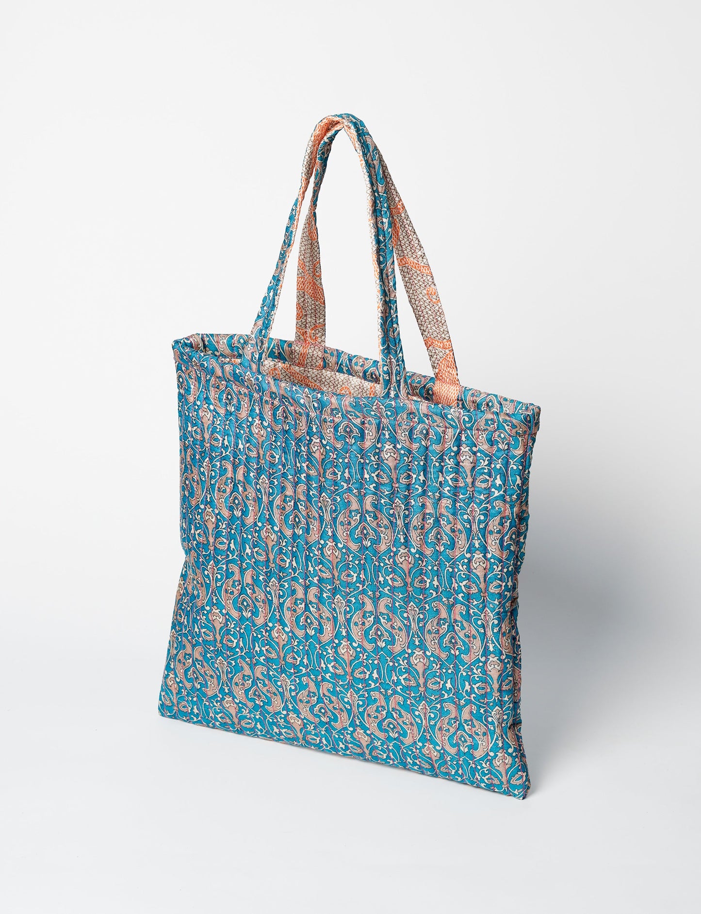Elevate your style sustainably with our QUILTED SHOPPER BAG. Soft textures, vibrant colors, and a positive impact on people and the planet. Perfect for the office, shopping, or happy hour. Crafted from pre-loved saris for eco-conscious fashionistas!