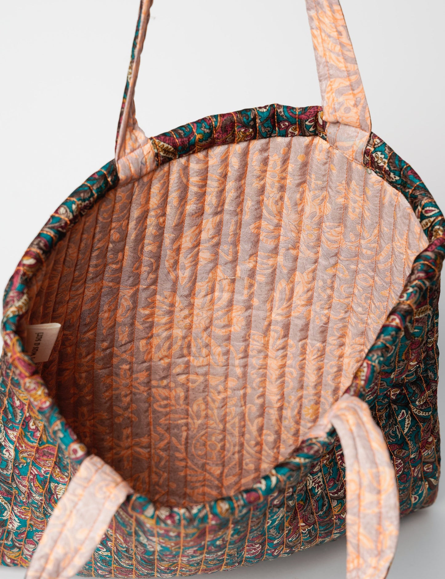 Elevate your style sustainably with our QUILTED SHOPPER BAG. Soft textures, vibrant colors, and a positive impact on people and the planet. Perfect for the office, shopping, or happy hour. Crafted from pre-loved saris for eco-conscious fashionistas!