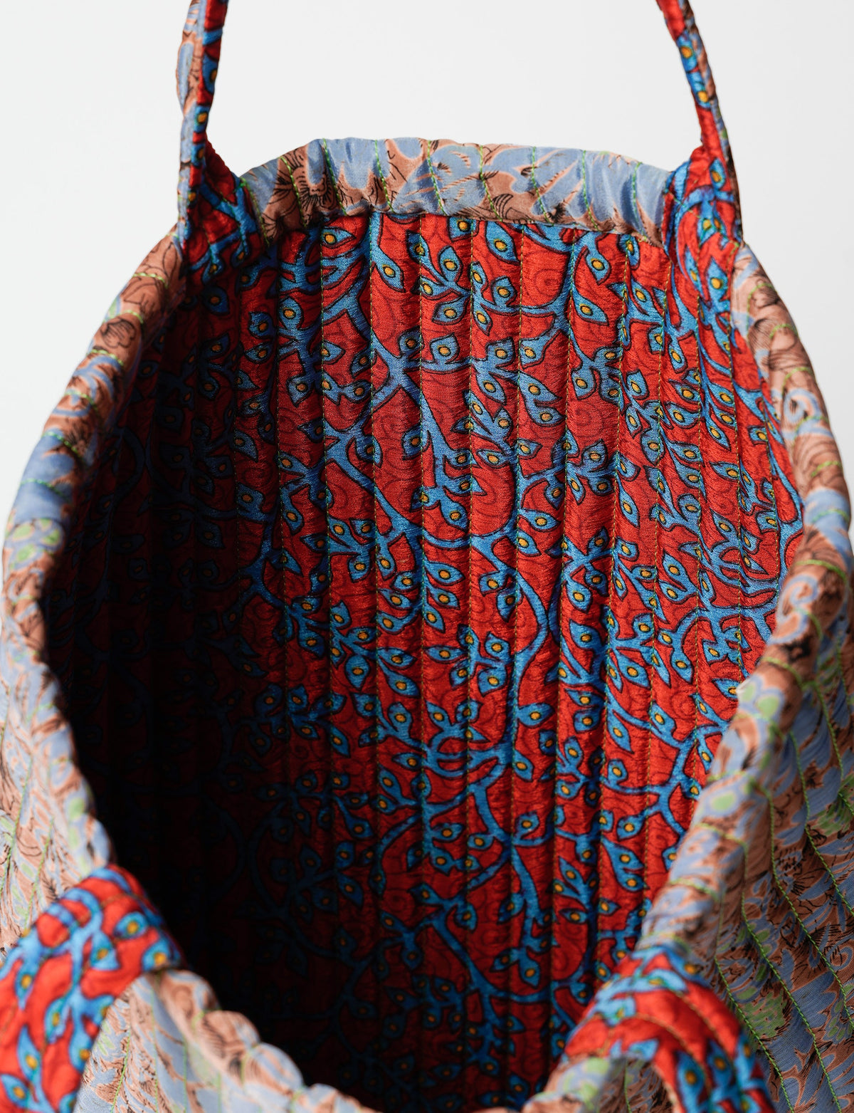 Elevate your style sustainably with our QUILTED SHOPPER BAG. Soft textures, vibrant colors, and a positive impact on people and the planet. Perfect for the office, shopping, or happy hour. Crafted from pre-loved saris for eco-conscious fashionistas!