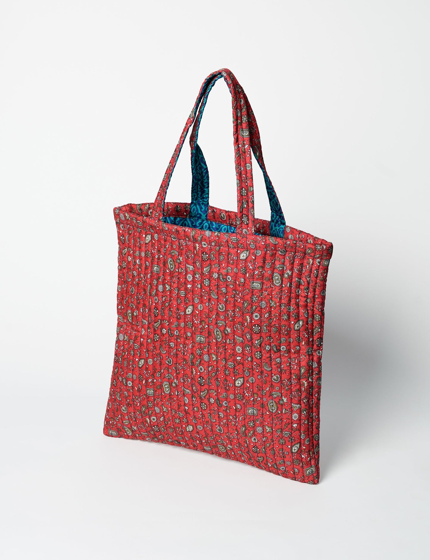 Elevate your style sustainably with our QUILTED SHOPPER BAG. Soft textures, vibrant colors, and a positive impact on people and the planet. Perfect for the office, shopping, or happy hour. Crafted from pre-loved saris for eco-conscious fashionistas!