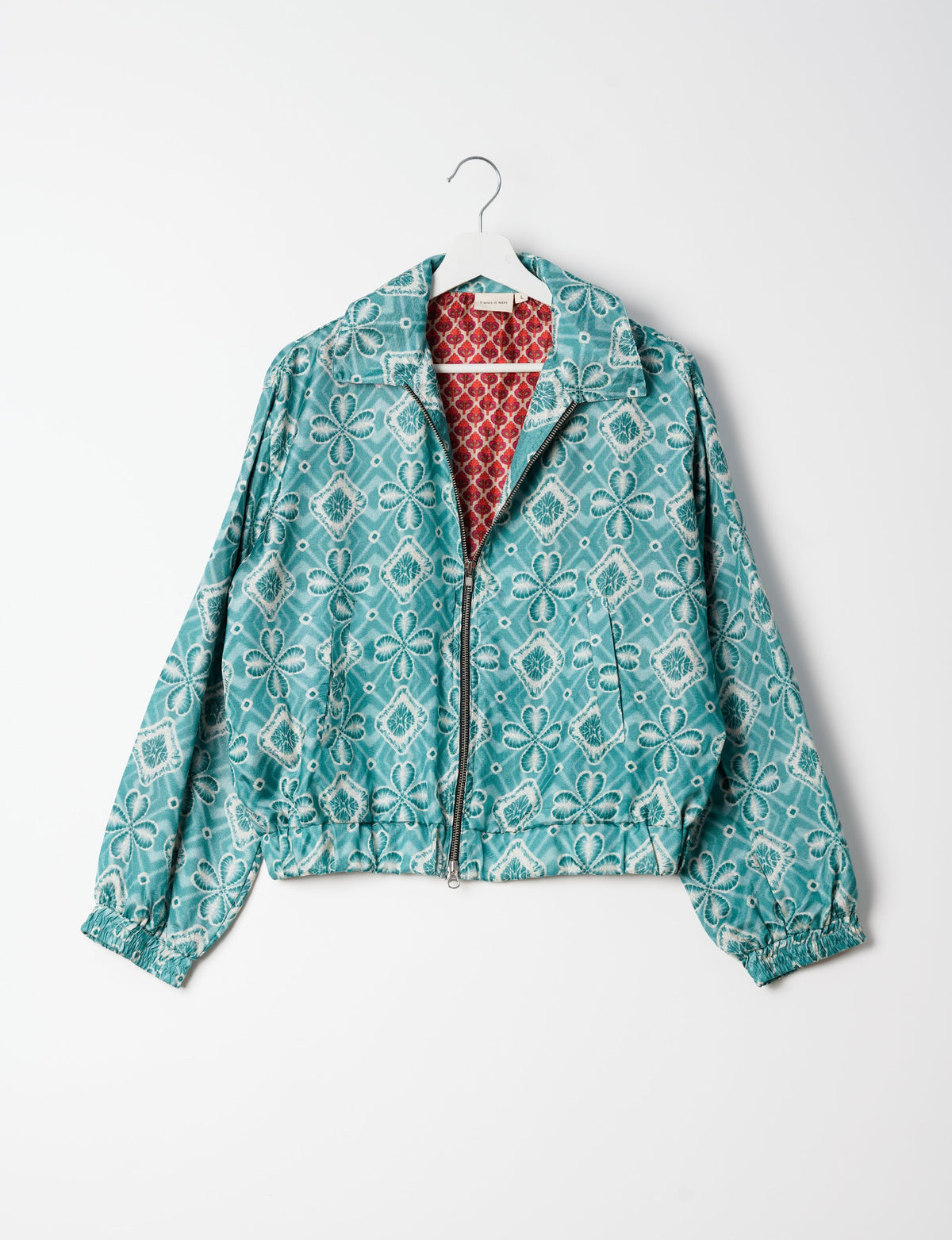 Stylish BOMBER JACKET, an upcycled clothing masterpiece with a cute cropped shape, elasticated details, and detachable metallic zipper. Contrast sari print lining adds a unique touch. Explore sustainable and eco-friendly fashion.