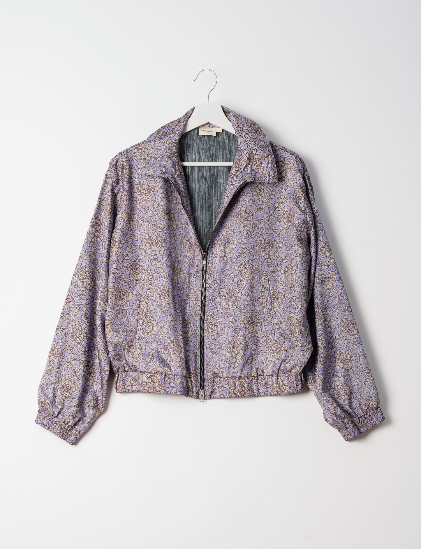 Stylish BOMBER JACKET, an upcycled clothing masterpiece with a cute cropped shape, elasticated details, and detachable metallic zipper. Contrast sari print lining adds a unique touch. Explore sustainable and eco-friendly fashion.