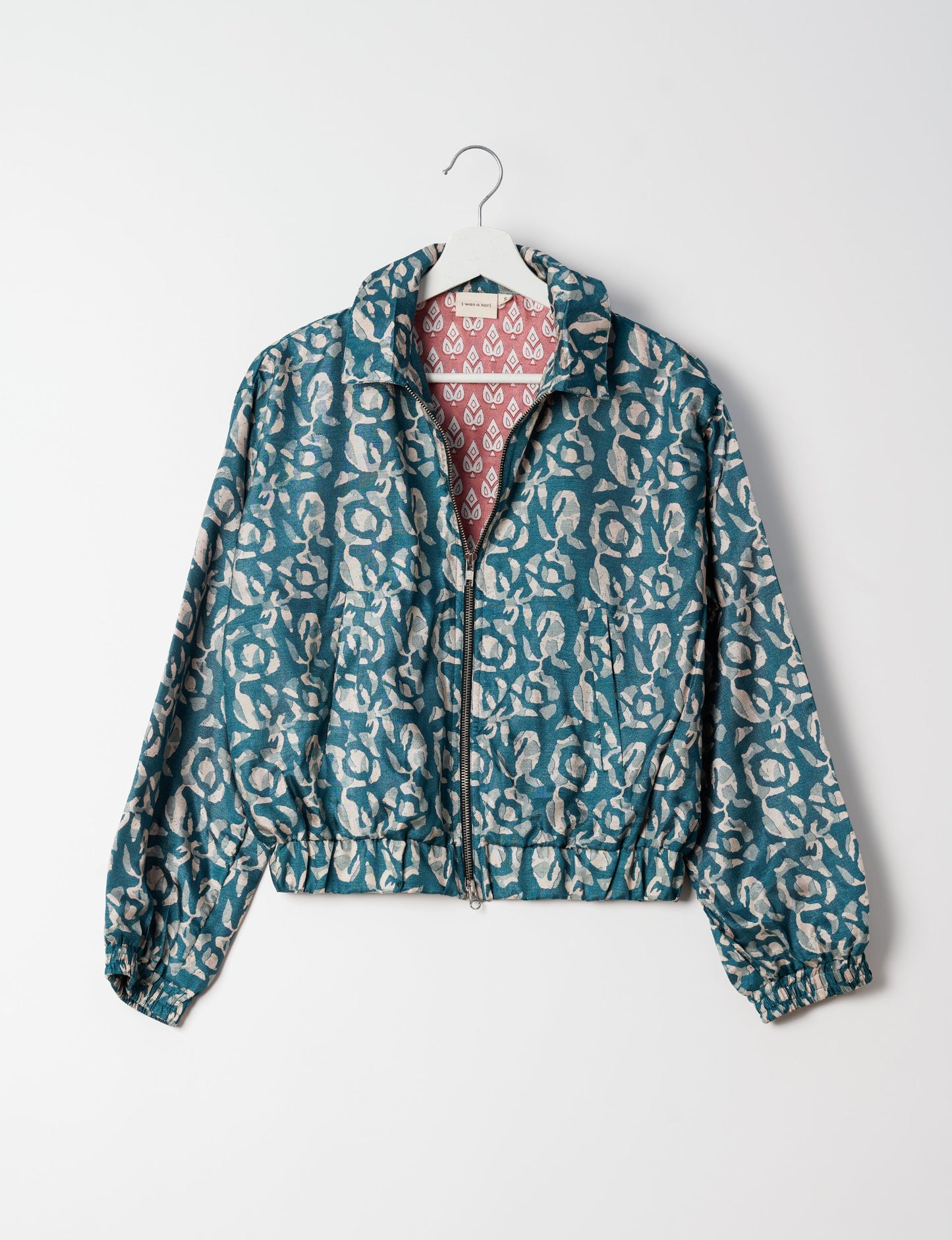 Stylish BOMBER JACKET, an upcycled clothing masterpiece with a cute cropped shape, elasticated details, and detachable metallic zipper. Contrast sari print lining adds a unique touch. Explore sustainable and eco-friendly fashion.