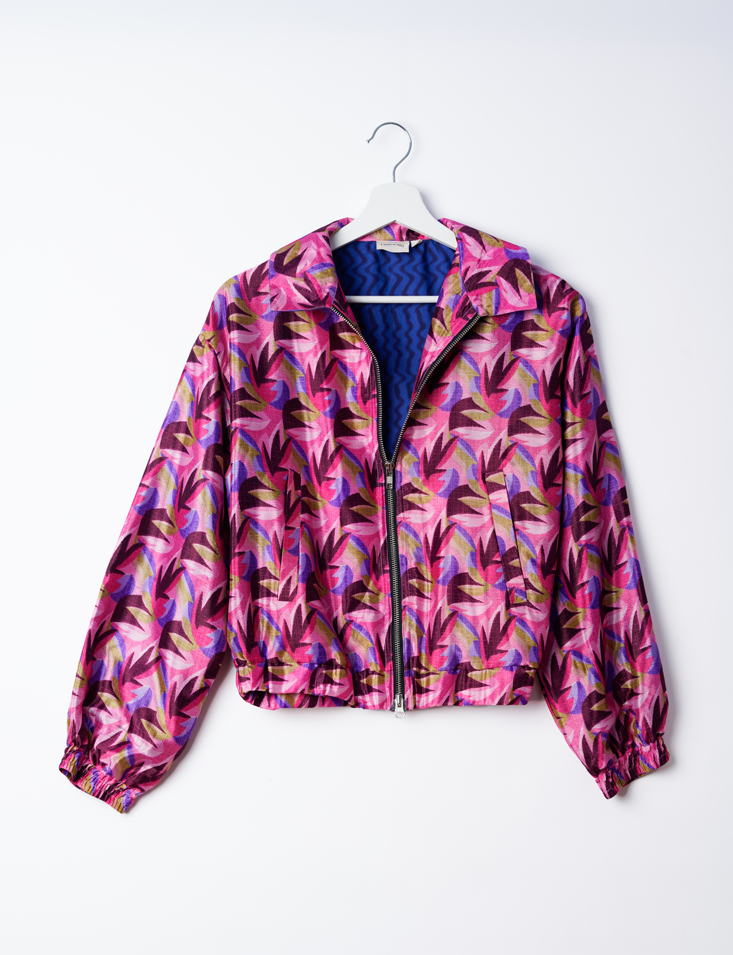 Stylish BOMBER JACKET, an upcycled clothing masterpiece with a cute cropped shape, elasticated details, and detachable metallic zipper. Contrast sari print lining adds a unique touch. Explore sustainable and eco-friendly fashion.