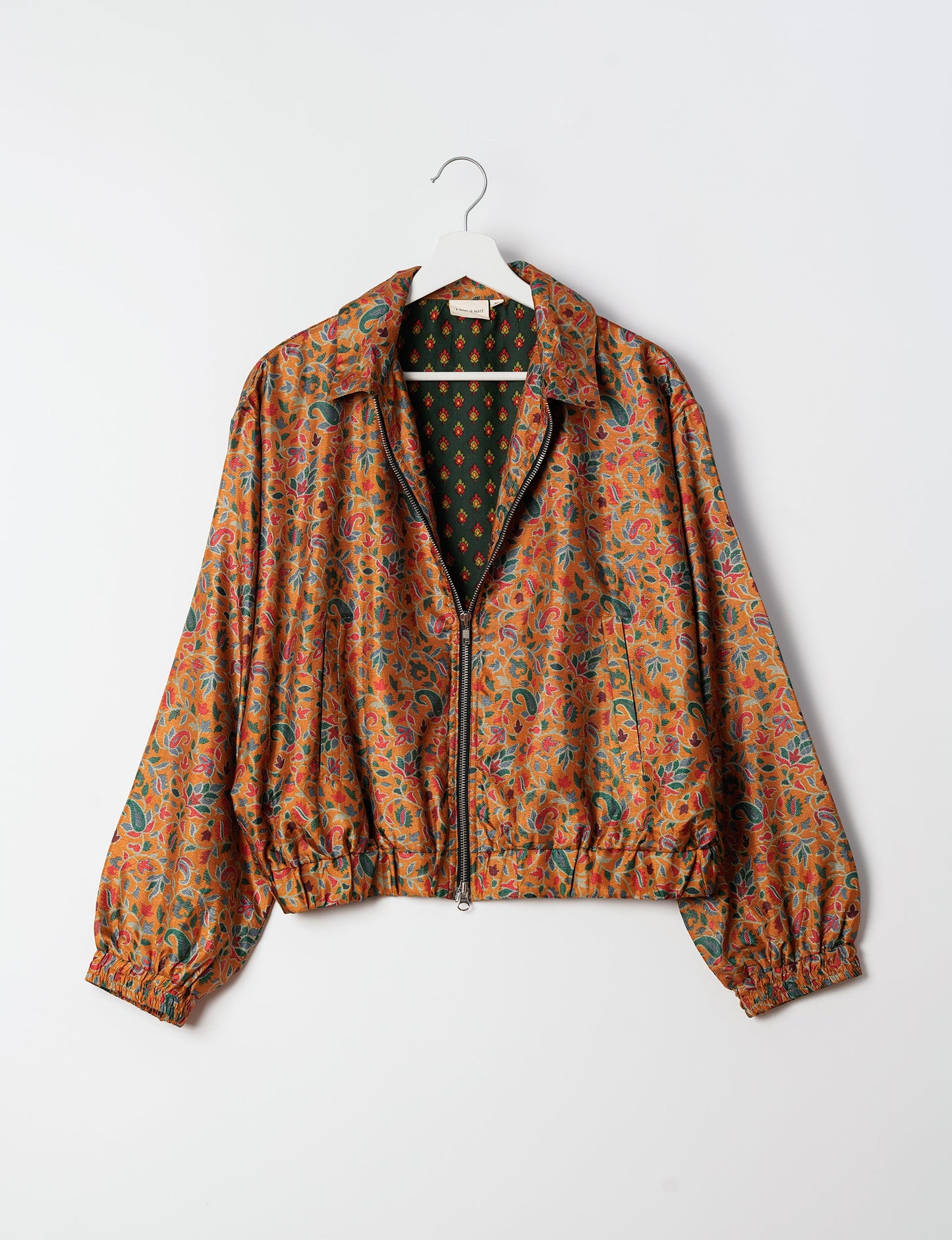 Stylish BOMBER JACKET, an upcycled clothing masterpiece with a cute cropped shape, elasticated details, and detachable metallic zipper. Contrast sari print lining adds a unique touch. Explore sustainable and eco-friendly fashion.