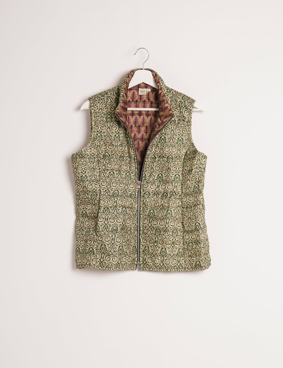Elevate your style with our QUILTED GILET, crafted from upcycled tropical saris. This sleeveless jacket, with its quilted warmth, is perfect for layering over tees or sweaters. Choose ethical, green fashion and experience the comfort of sustainable living with a touch of home.