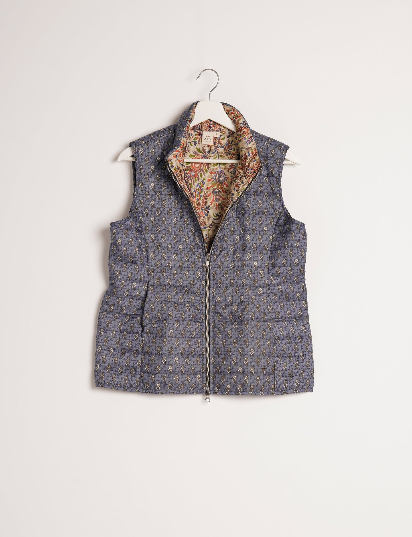 Elevate your style with our QUILTED GILET, crafted from upcycled tropical saris. This sleeveless jacket, with its quilted warmth, is perfect for layering over tees or sweaters. Choose ethical, green fashion and experience the comfort of sustainable living with a touch of home.