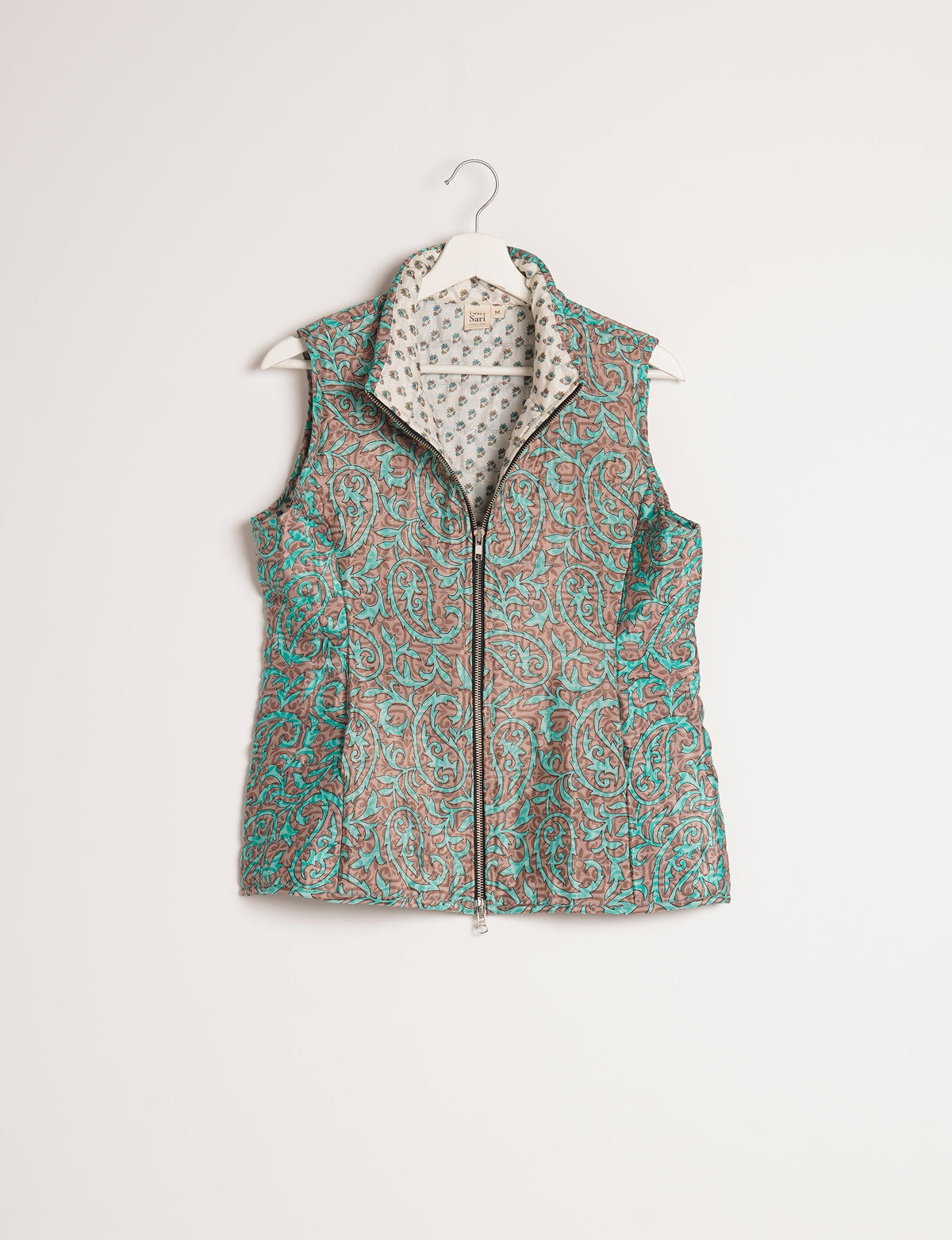 Elevate your style with our QUILTED GILET, crafted from upcycled tropical saris. This sleeveless jacket, with its quilted warmth, is perfect for layering over tees or sweaters. Choose ethical, green fashion and experience the comfort of sustainable living with a touch of home.