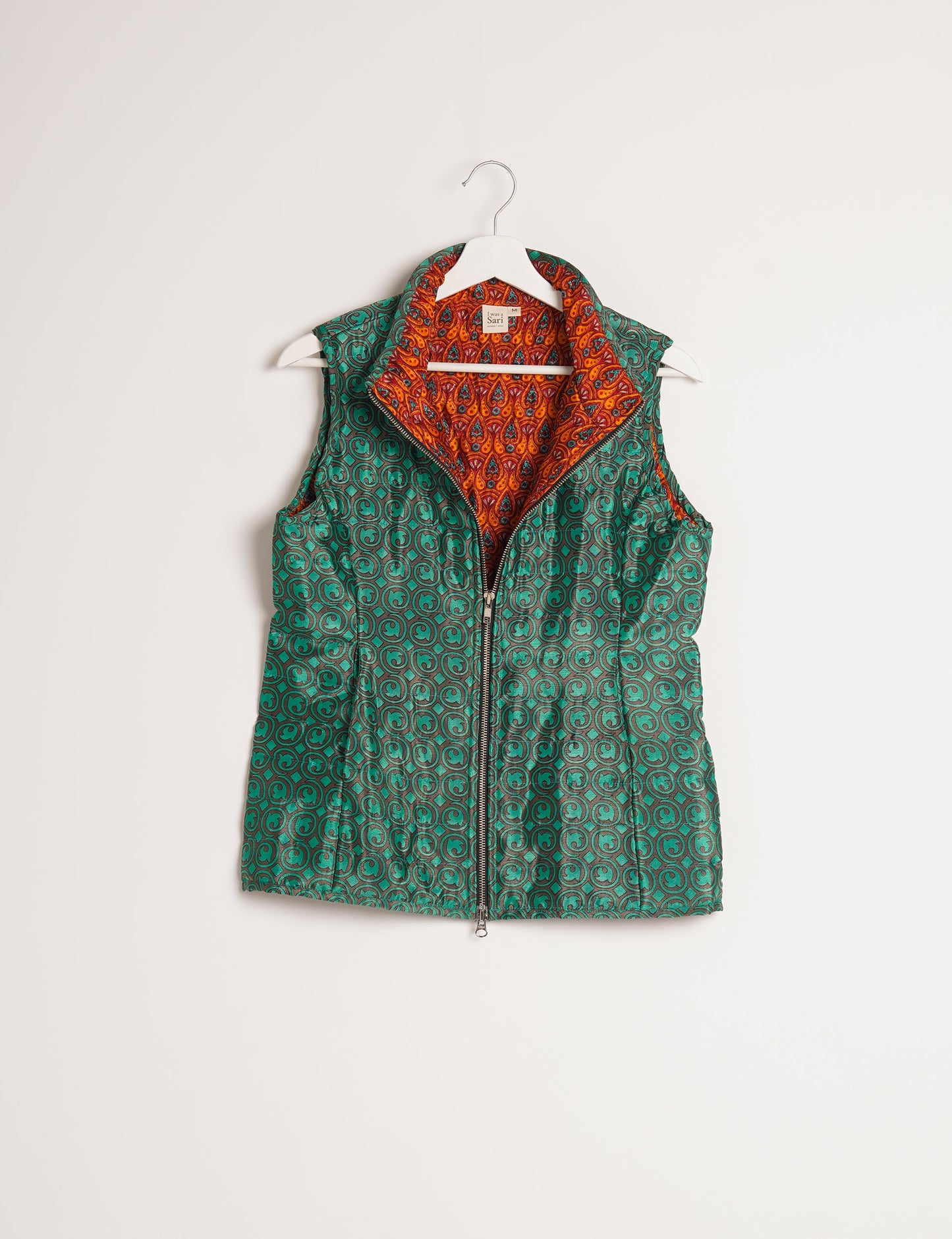 Elevate your style with our QUILTED GILET, crafted from upcycled tropical saris. This sleeveless jacket, with its quilted warmth, is perfect for layering over tees or sweaters. Choose ethical, green fashion and experience the comfort of sustainable living with a touch of home.