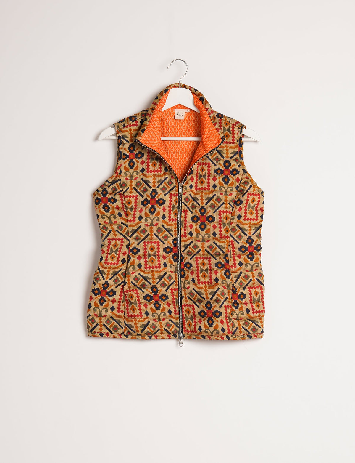 Elevate your style with our QUILTED GILET, crafted from upcycled tropical saris. This sleeveless jacket, with its quilted warmth, is perfect for layering over tees or sweaters. Choose ethical, green fashion and experience the comfort of sustainable living with a touch of home.