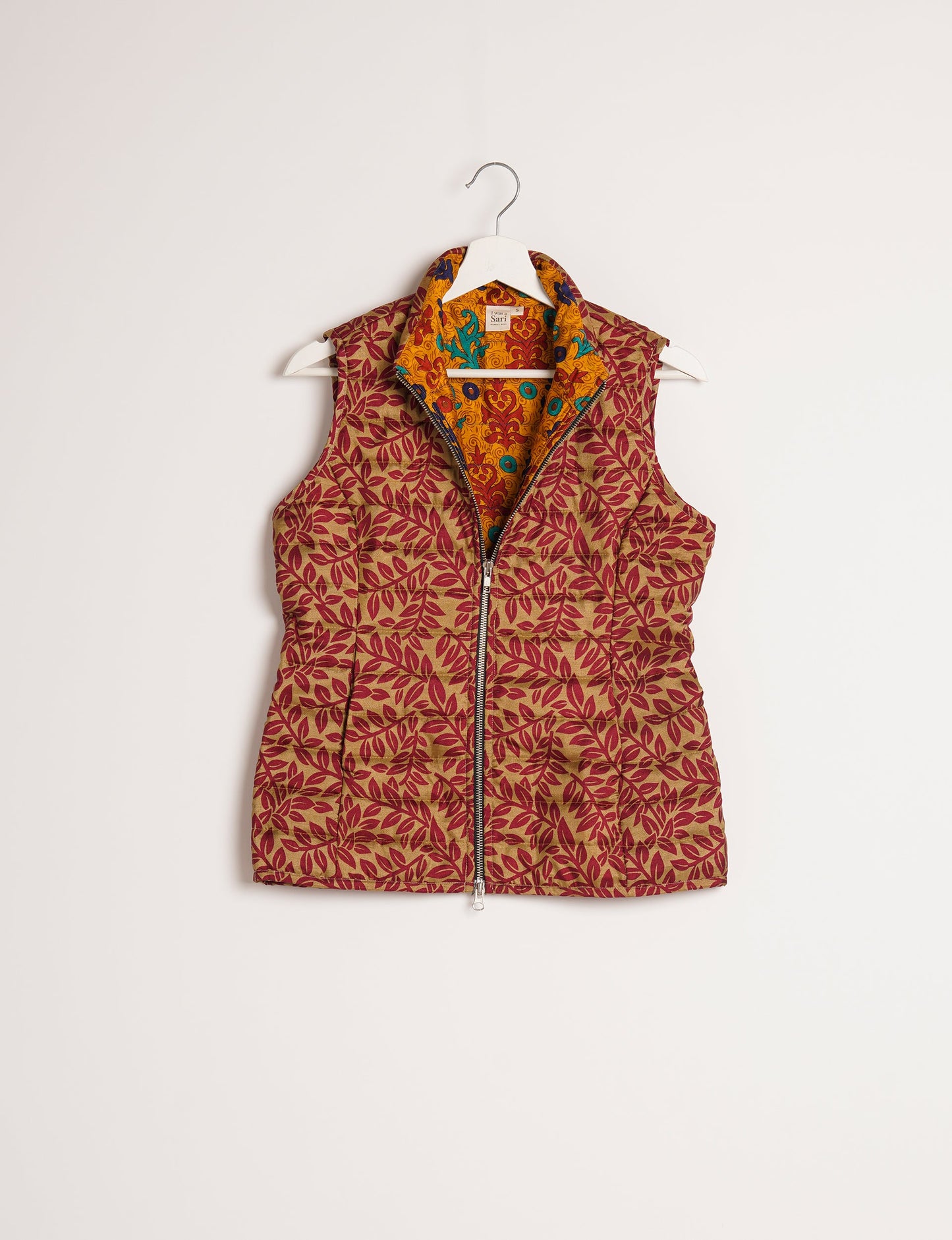 Elevate your style with our QUILTED GILET, crafted from upcycled tropical saris. This sleeveless jacket, with its quilted warmth, is perfect for layering over tees or sweaters. Choose ethical, green fashion and experience the comfort of sustainable living with a touch of home.