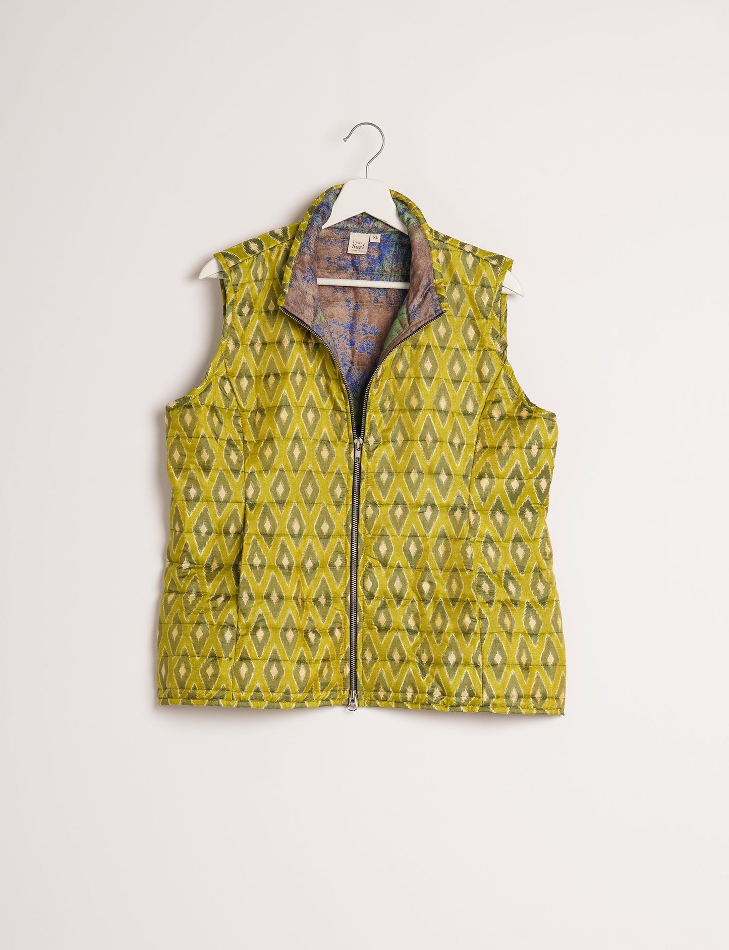 Elevate your style with our QUILTED GILET, crafted from upcycled tropical saris. This sleeveless jacket, with its quilted warmth, is perfect for layering over tees or sweaters. Choose ethical, green fashion and experience the comfort of sustainable living with a touch of home.