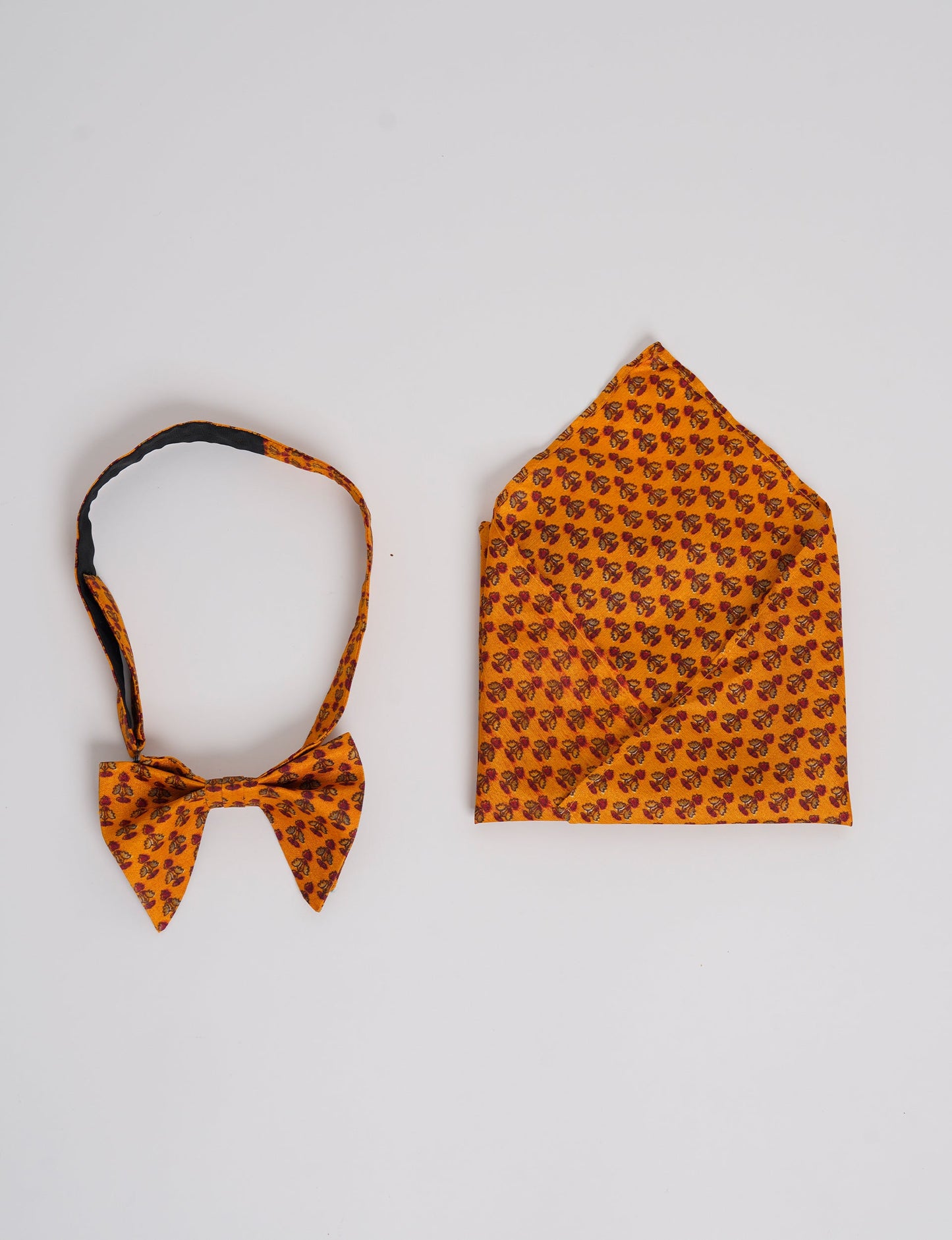 Dapper BOW TIE & POCKET SQUARE SET, ethically handcrafted with lively prints and eye-catching colors. Made by Mumbai-based craftswomen, this ensemble adds excitement to classic formal-wear. Sustainable fashion supporting fair trade, slow fashion, and empowering women artisans. A powerful story of transformation.