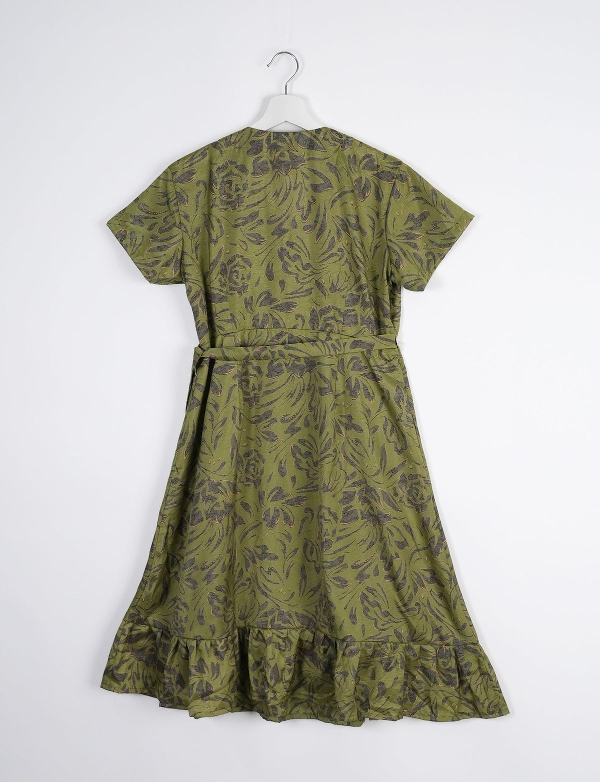 Embrace timeless elegance with our MIDI WRAP DRESS – a midi-length beauty featuring a v-neck, flattery from all angles, and a charming sari belt. Crafted from sustainable materials, this dress embodies ethical clothing and green fashion. Sophisticated with a frill tier at the hem and short cap sleeves, this dress is perfect for any occasion. Tie up the beautifully crafted sari belt on the side for a versatile, stylish, and eco-friendly look.