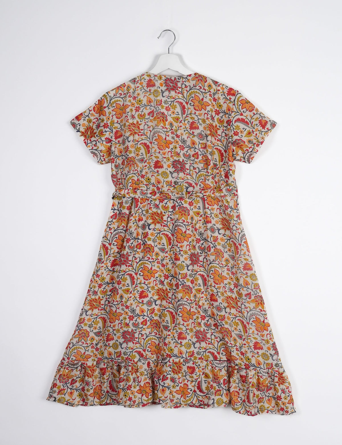 Embrace timeless elegance with our MIDI WRAP DRESS – a midi-length beauty featuring a v-neck, flattery from all angles, and a charming sari belt. Crafted from sustainable materials, this dress embodies ethical clothing and green fashion. Sophisticated with a frill tier at the hem and short cap sleeves, this dress is perfect for any occasion. Tie up the beautifully crafted sari belt on the side for a versatile, stylish, and eco-friendly look.