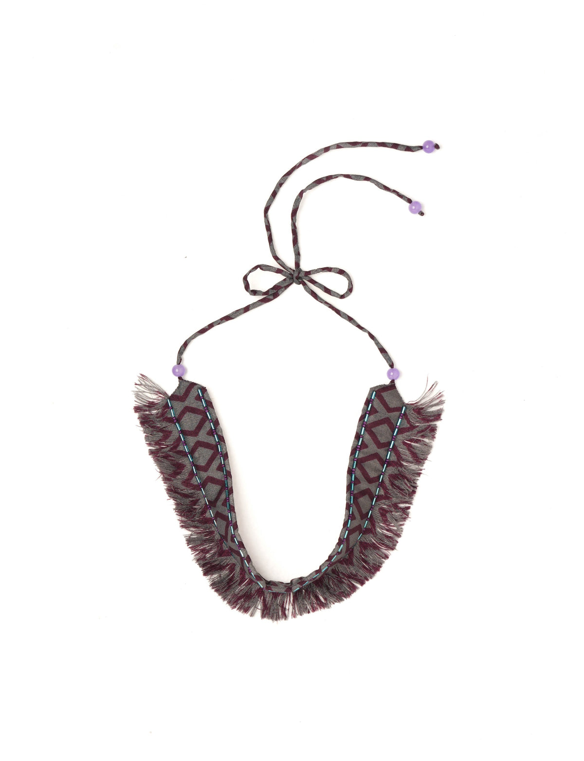 Discover the charm of our Tie-Up Fringe Choker, a meticulously crafted necklace with sari fringe edging and a tie-up back. Adorned with Indian salli beads by skilled female artisans in Mumbai, this accessory embodies ethical fashion and sustainable elegance.