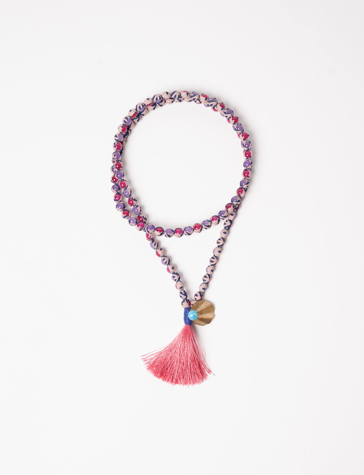 Discover elegance in our Beaded Tassel Necklace, meticulously handcrafted with glass beads, a silk tassel, and a metallic pendant. Hypoallergenic metal hooks provide a skin-friendly and stylish accessory. Length: 57 cm / 22.5 inches.