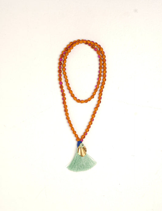 Discover elegance in our Beaded Tassel Necklace, meticulously handcrafted with glass beads, a silk tassel, and a metallic pendant. Hypoallergenic metal hooks provide a skin-friendly and stylish accessory. Length: 57 cm / 22.5 inches.