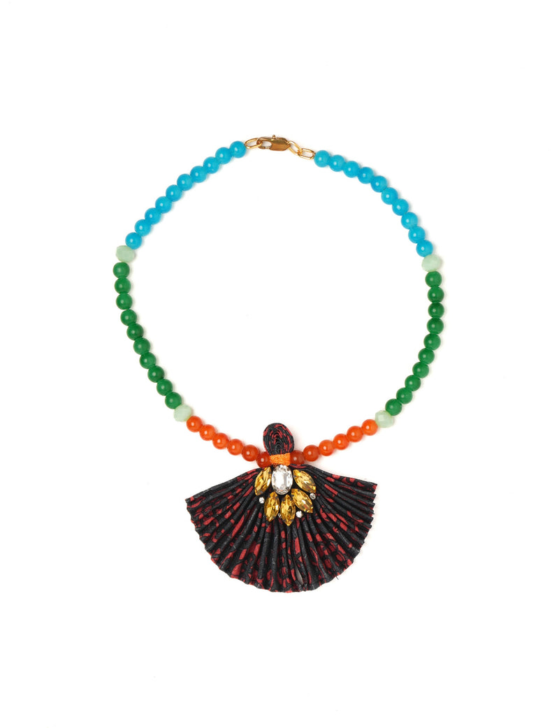 Beaded necklace with blue, green, and orange beads and a black pleated fabric pendant with yellow and clear gems