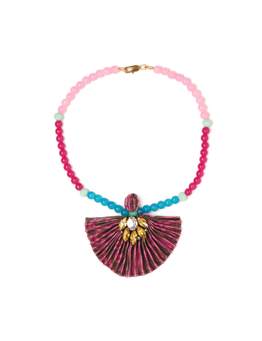 Dive into sustainable fashion with our PLEATED NECKLACE, a creation by talented female artisans in Mumbai. The pleated fan pendant, made from upcycled saris, hangs on a colorful necklace crafted from glass beads, embellished with sparkling glass crystals. An ethical, green fashion statement for conscious styling.