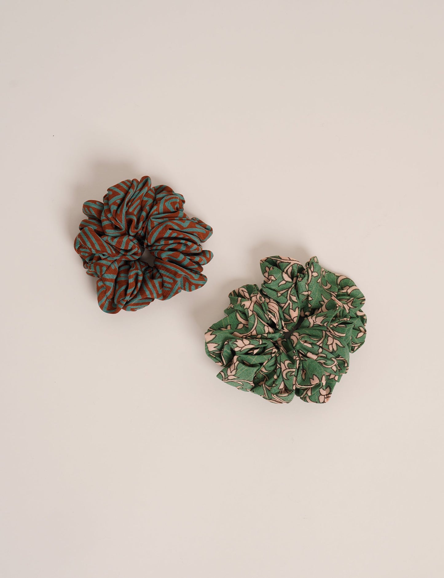 Upgrade your hairstyle with our Scrunchy Set of 2 – elastic hair ties wrapped in colorful Indian sari fabric. A top pick in ethical and green fashion, these eco-friendly prints add flair to your wrist and hair, making a sustainable style statement that catches attention and sparks change.