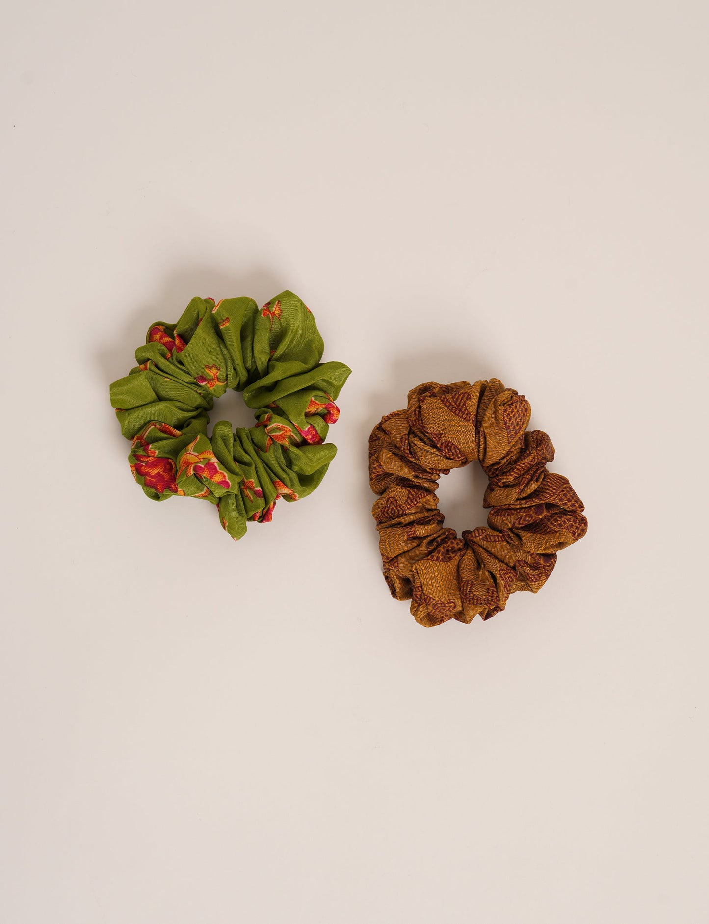 Upgrade your hairstyle with our Scrunchy Set of 2 – elastic hair ties wrapped in colorful Indian sari fabric. A top pick in ethical and green fashion, these eco-friendly prints add flair to your wrist and hair, making a sustainable style statement that catches attention and sparks change.